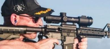 Navy-commander-shooting-rifle-with-scope-backwards-640x480.jpg